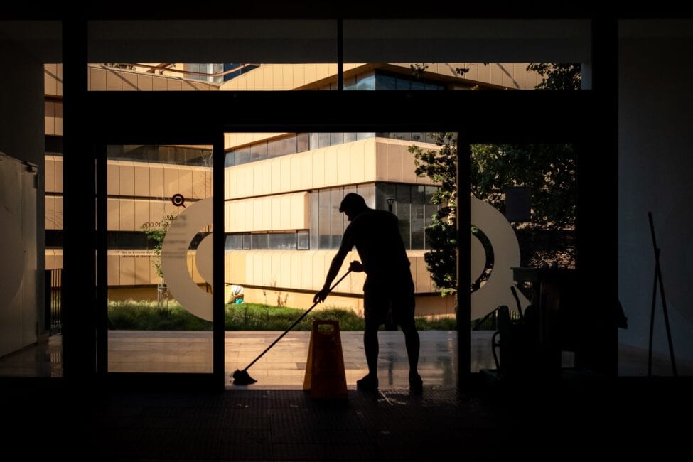 A Jantize America employee cleaning a commercial building.