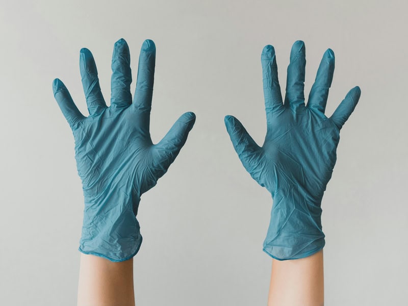 Jantize professional ready to clean an office with protective gloves on.